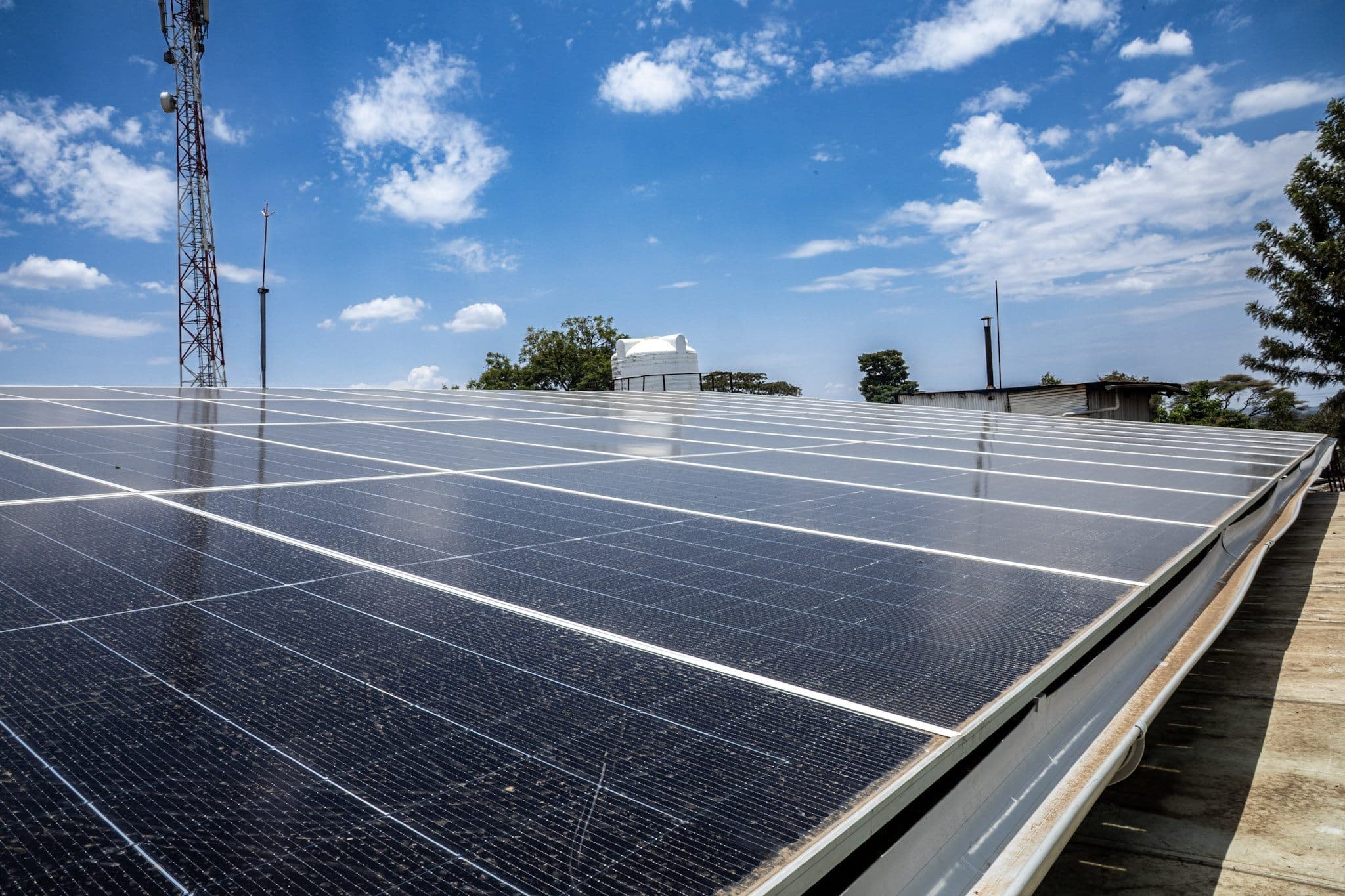 Rooftop solar panels under a bright blue sky